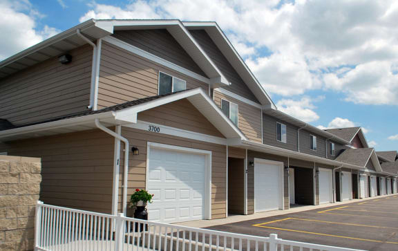 a row of garages in a row with a cloudy sky in the background