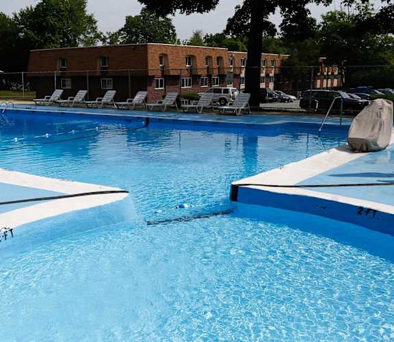 A large blue swimming pool with a white line on the edge.
