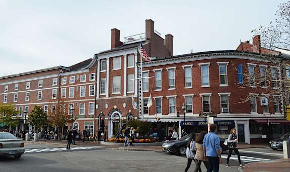 A large red brick building with a flag on the roof.