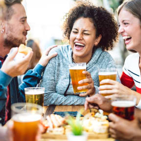 Friends Having Drinks Together Smiling