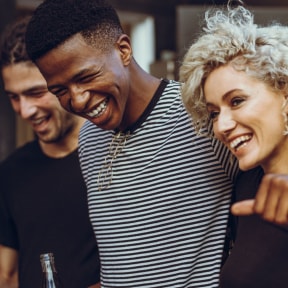 a group of men and women smiling and laughing at a bar at Arlo Luxury homes Apartments, Little Rock, Arkansas