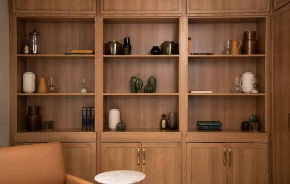a living room filled with furniture and a large wooden bookcase