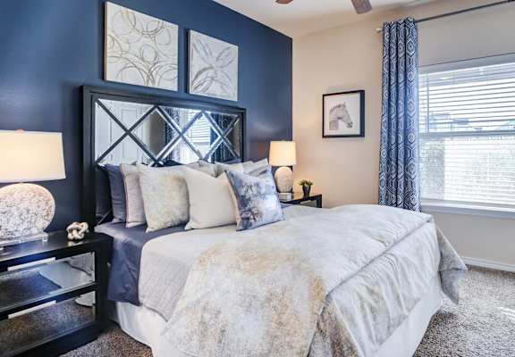 Model Bedroom with Bed and Nightstands and Large Window at Residence at Midland, Texas