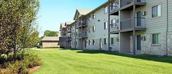 Apartment building with a green lawn in front.