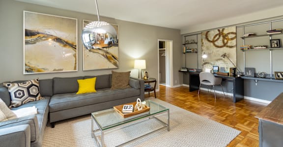 a living room with a couch and a glass coffee table