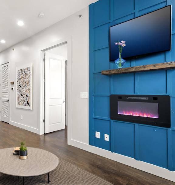 State Street Flats Apartments modern living room with a grey sofa and a coffee table.