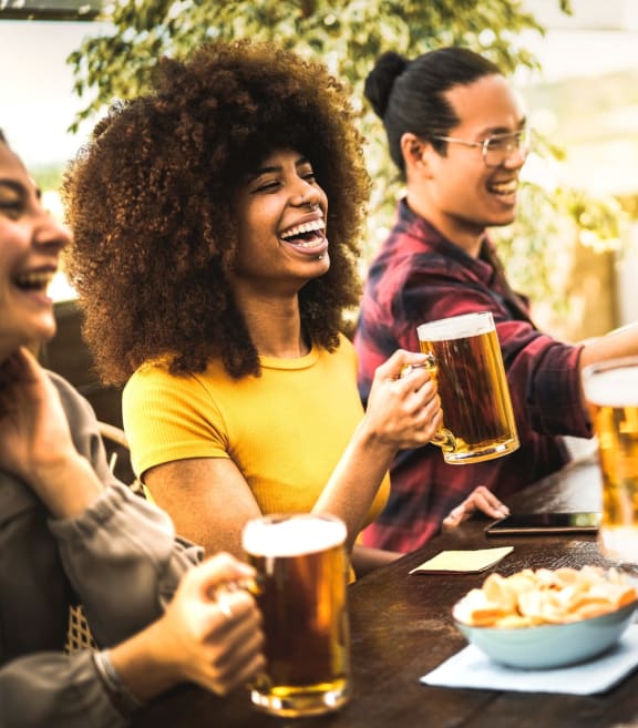 Friends Smiling Having Snacks and Drinks Together