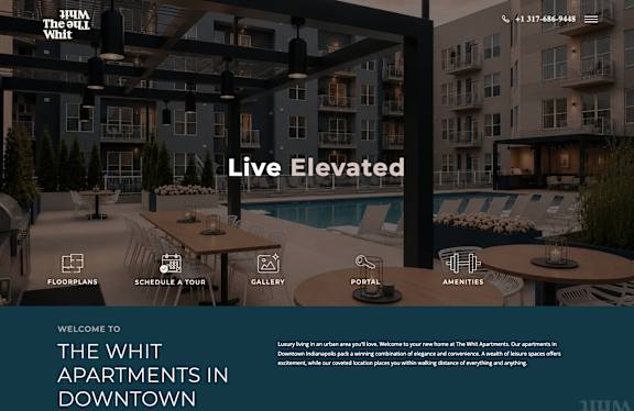 A website banner for The Whit Apartments featuring a live elevated view of the building.