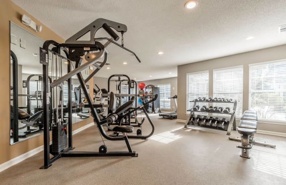 the gym at the west end of the home is equipped with weights and cardio equipment at Mill Creek Place, Douglasville Georgia