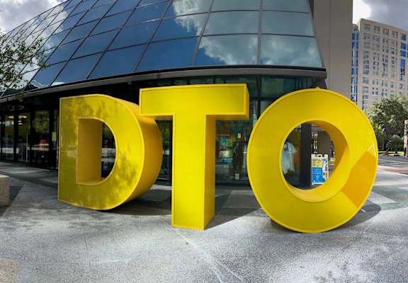 a large yellow dot sign in front of a building