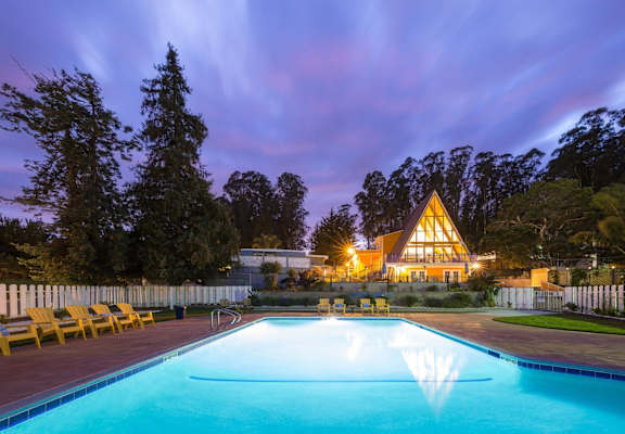 pool view with the main cabin in the background at Salinas Sunset Apartments, Salinas, CA, 93907