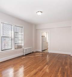 a living room with a couch and a table and a kitchen