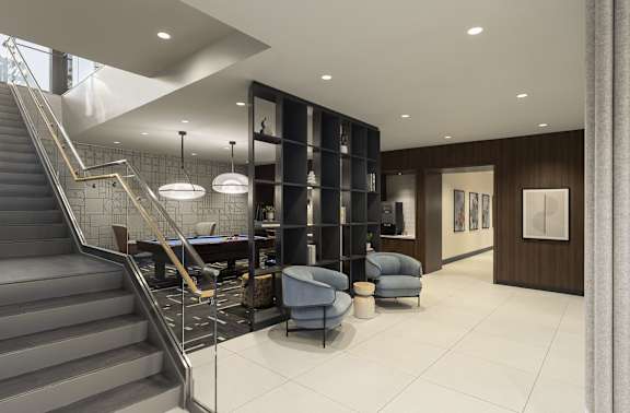 A modern interior with a staircase, a pool table, and a bar.
