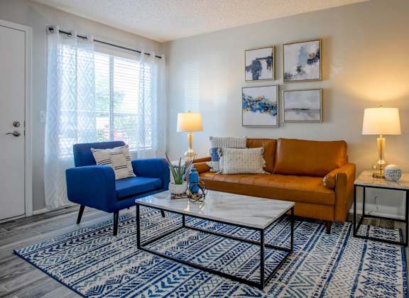 a living room with a couch chair and coffee table