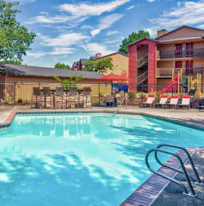 Alvista 23 Apartment Homes Clubhouse and Pool with Lounge Chairs