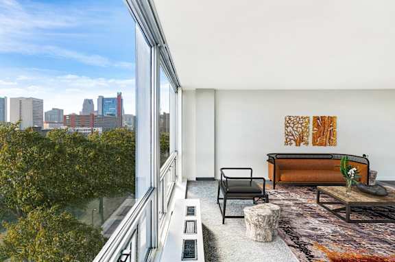A modern living room with a view of the city skyline.