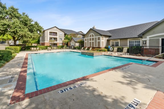 Valley Trails Apartments in Irving, Texas Exterior and Pool with Lounge Chairs