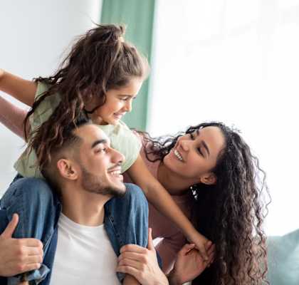 Young Family Holding Each Other Smiling