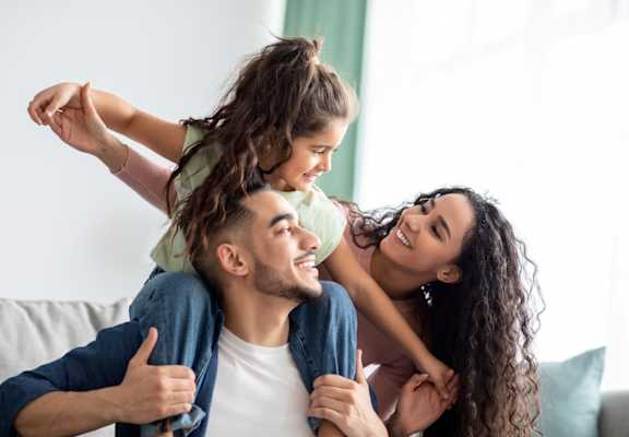 Young Family Holding Each Other Smiling