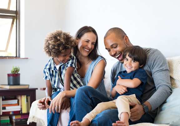 A family is sitting on a couch at Arlo Luxury Apartment Homes, Little Rock, AR