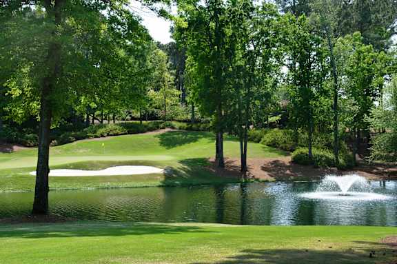 A golf course with a pond and a fountain at The Walker, Cary, North Carolina