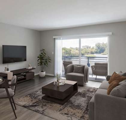 A modern living room with a glass table and grey chairs.