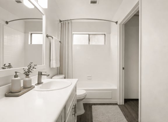 A bathroom with a white sink, toilet, and bathtub.
