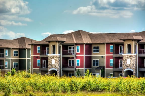 a row of apartment buildings with blue sky in the background at Villa Espada Apartments, San Antonio, Texas