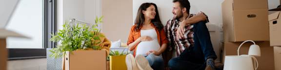 Man and Woman Sitting on Floor in New Home Together