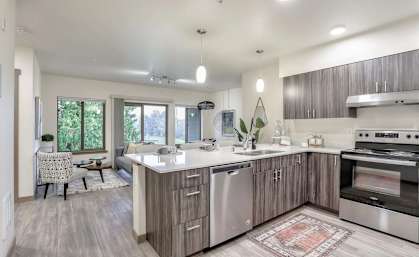 A modern kitchen with a large island and stainless steel appliances.