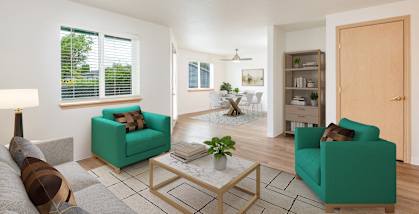 A living room with a green couch, a coffee table, and a lamp.at Vancouver Mall Apartments, Vancouver, WA 98662