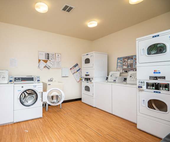 a laundry room with washer and dryers and washing machines