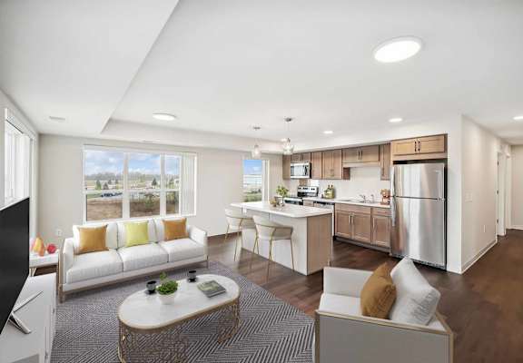 a living room and kitchen with a couch and a table