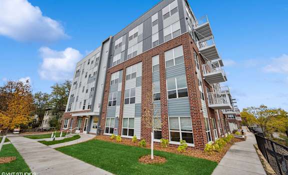 A modern apartment building with a mix of brick and panel facades.