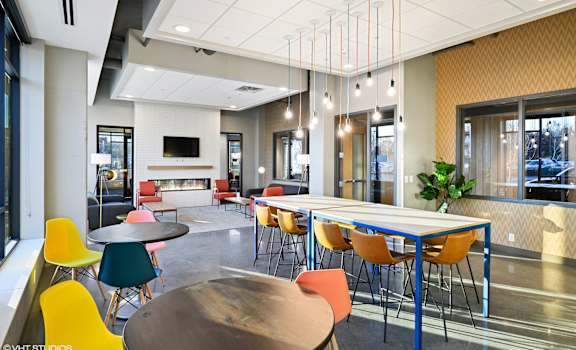 A modern conference room with a long table and chairs.