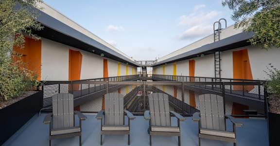 a patio with rocking chairs on a balcony