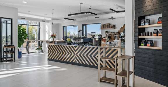 A modern store interior with a black and white striped counter.