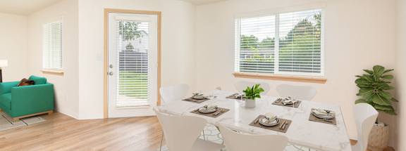 A dining room with a white table and chairs.at Vancouver Mall Apartments, Vancouver, WA 98662