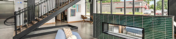 a living room with a fireplace and a staircase