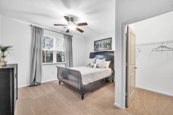 a bedroom with a bed and a ceiling fan