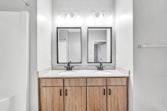 a bathroom with two mirrors and two sinks
