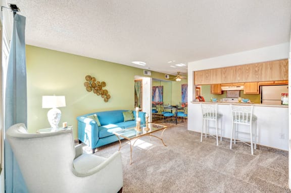 Bright living room with pass through kitchen at with Cardio & Strength Training Equipment at Country Club at The Meadows in Las Vegas, NV!