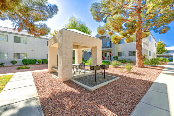 Gazeebo in the courtyard at Lush landscaping path at Country Club at The Meadows Senior Apartments in Las Vegas, NV, For Rent. Now leasing 1 and 2 bedroom apartments.