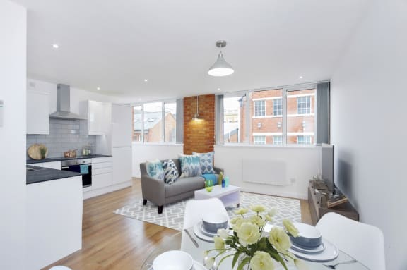 a kitchen with white cabinets and a table and chairs