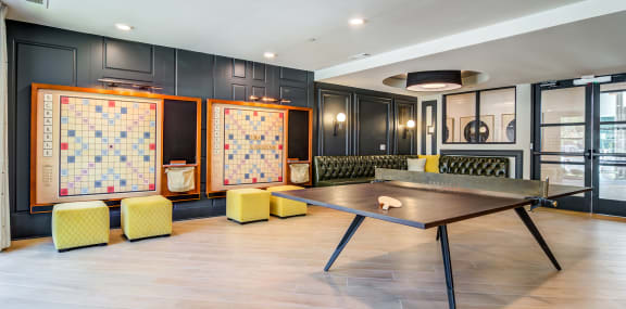 game room with ping pong table and chairs at the district flats apartments