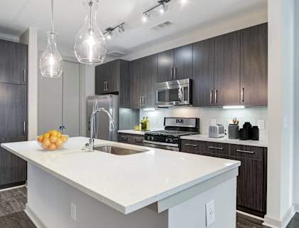 a kitchen with a large white counter top and a sink