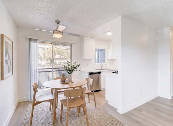 A dining room with a table and chairs.