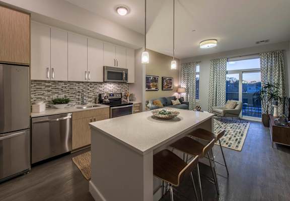 Open-concept kitchen and living area at RE150 apartments in Medford, MA