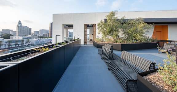 a long terrace with benches and a view of the city