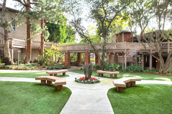 a courtyard with benches in front of a building